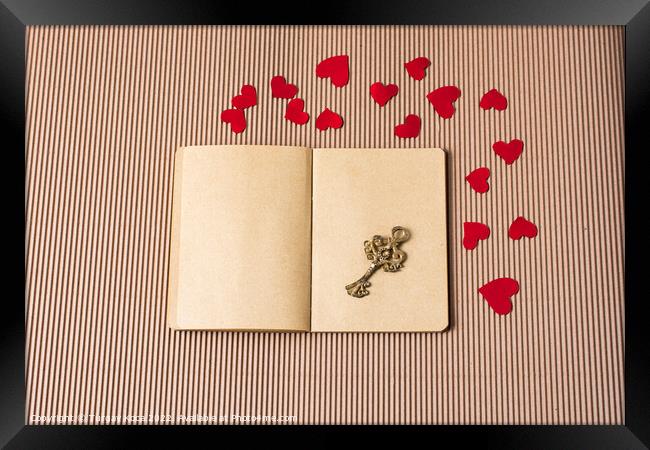 paper hearts around notebook with a retro key  Framed Print by Turgay Koca