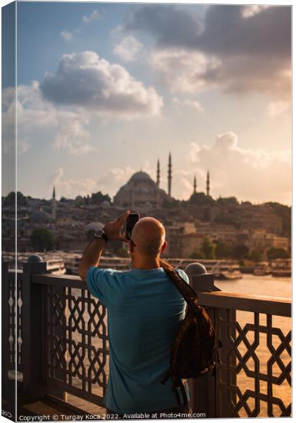 Man  taking pictures on Galata bridge. Vacation in Istanbul.  Canvas Print by Turgay Koca