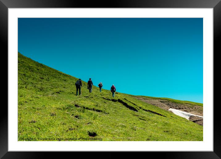 hikers with backpacks and trekking poles walking in Artvin highl Framed Mounted Print by Turgay Koca