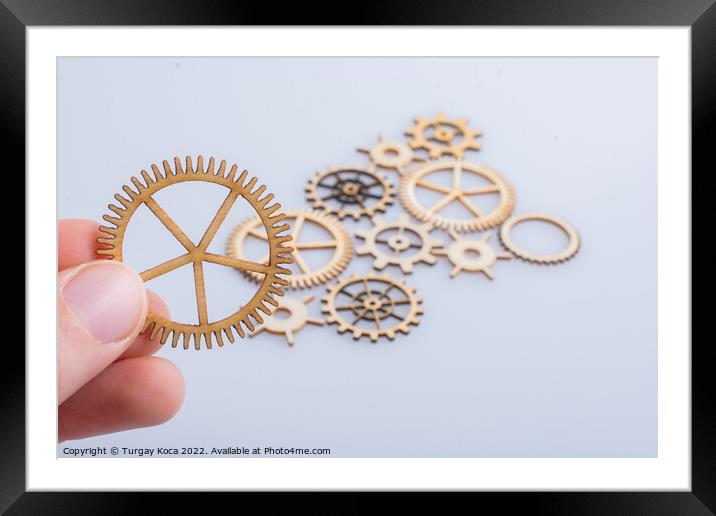 Gear wheel in hand on white background as concept of engineering Framed Mounted Print by Turgay Koca