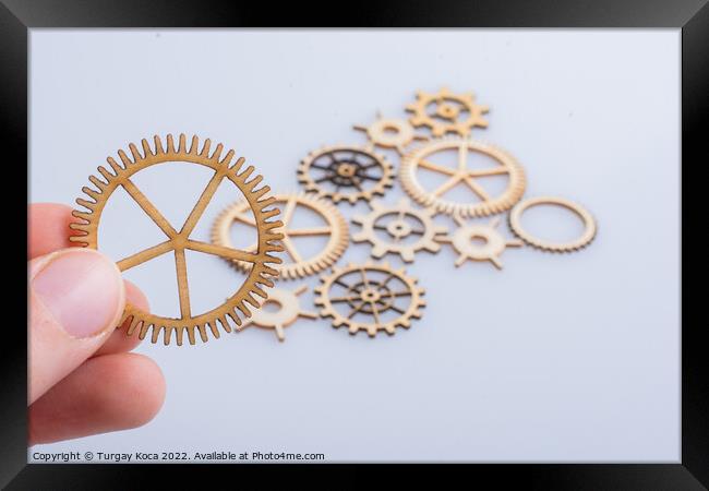 Gear wheel in hand on white background as concept of engineering Framed Print by Turgay Koca