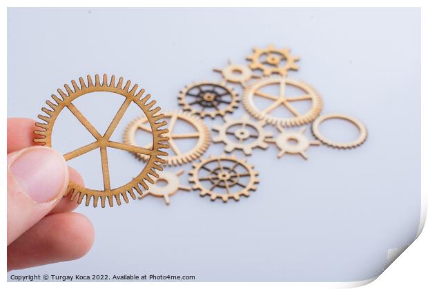 Gear wheel in hand on white background as concept of engineering Print by Turgay Koca