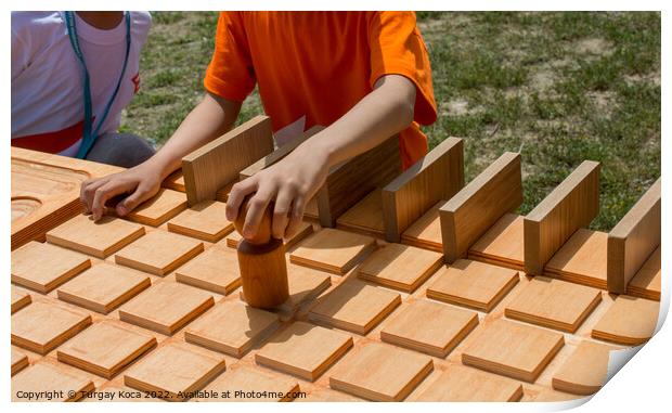 Hand holding wooden puzzle element in hand Print by Turgay Koca