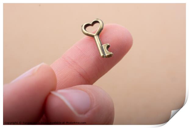 Tiny key with heart shape on the finger tip Print by Turgay Koca