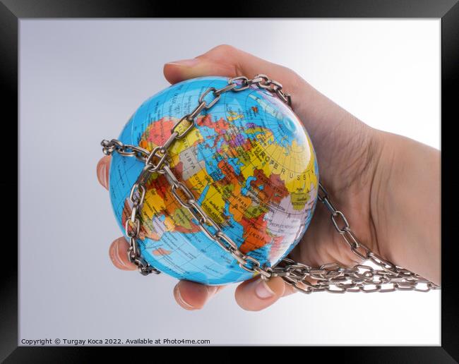 Chained globe Framed Print by Turgay Koca
