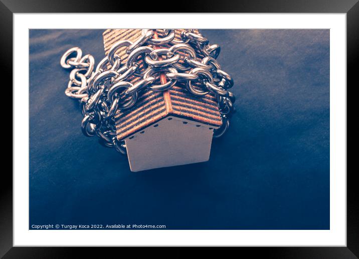 Chain around a Little model house in view Framed Mounted Print by Turgay Koca