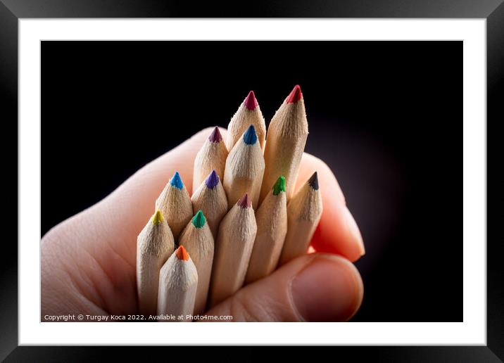 Hand holding colored pencils for creative idea and concept.  Framed Mounted Print by Turgay Koca