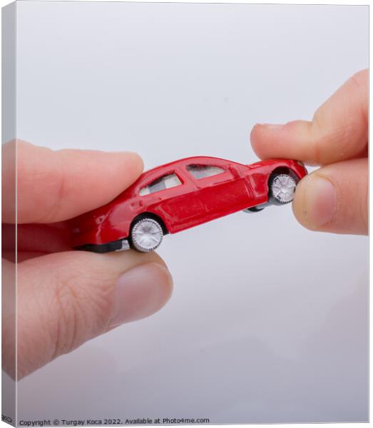 Child giving out little toy car Canvas Print by Turgay Koca