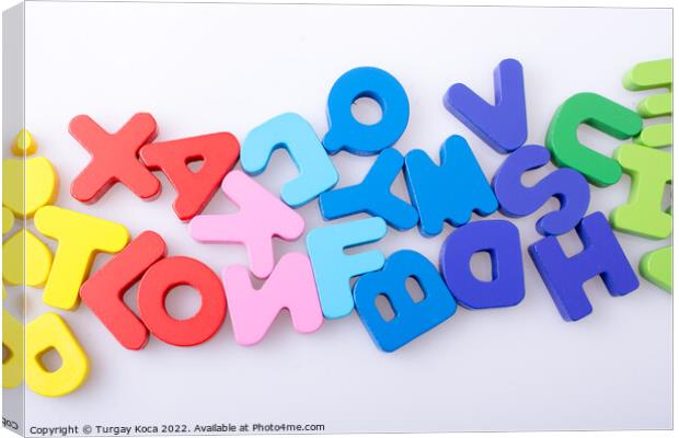 Colorful letter blocks scattered randomly on white Canvas Print by Turgay Koca