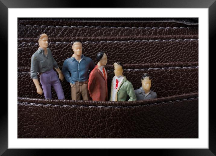 Tiny figurine of men model  in pockets Framed Mounted Print by Turgay Koca