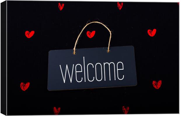 Welcome on black notice board  with red hearts around Canvas Print by Turgay Koca