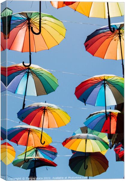 Colored umbrellas hanging above the street Canvas Print by Turgay Koca
