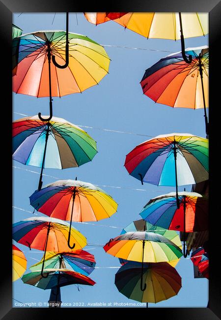 Colored umbrellas hanging above the street Framed Print by Turgay Koca