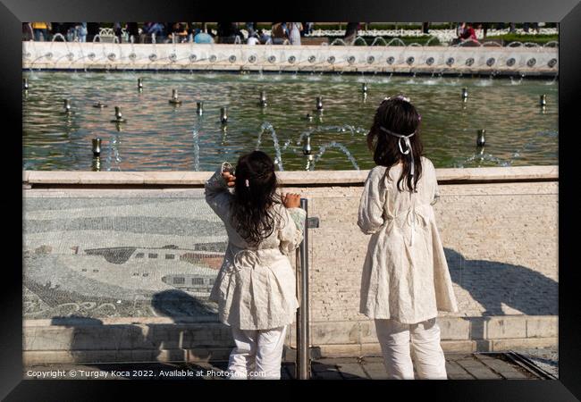 little girls by the pool with domes in view Framed Print by Turgay Koca