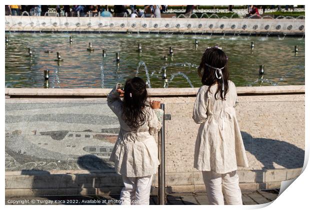 little girls by the pool with domes in view Print by Turgay Koca
