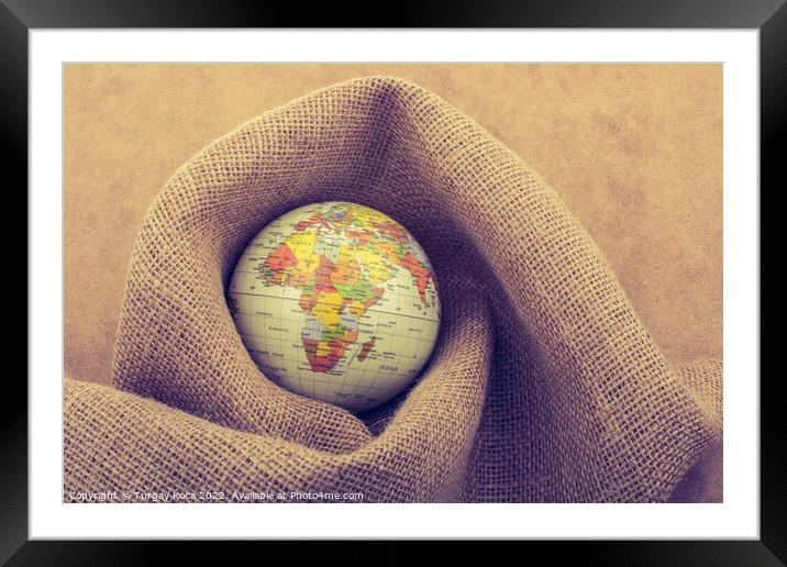 Globe placed on canvas background Framed Mounted Print by Turgay Koca