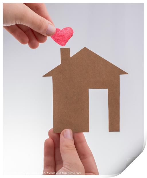 Hand holding a heart on a paper house  Print by Turgay Koca