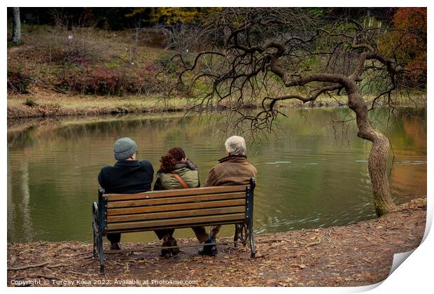 People seat on wooden bench by the lake in nature Print by Turgay Koca