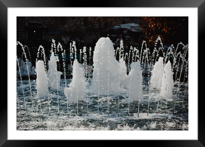 The fountains gushing sparkling water in a pool Framed Mounted Print by Turgay Koca