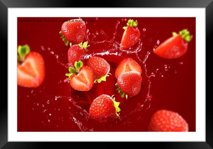 Strawberry falling into the lot of juice Framed Mounted Print by Stan Lihai
