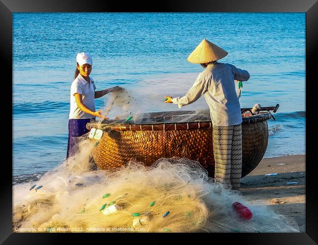 Folding the nets, Mui Ne, Vietnam Framed Print by Kevin Hellon