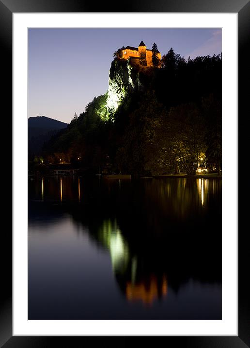 Lake Bled castle reflected at dusk Framed Mounted Print by Ian Middleton