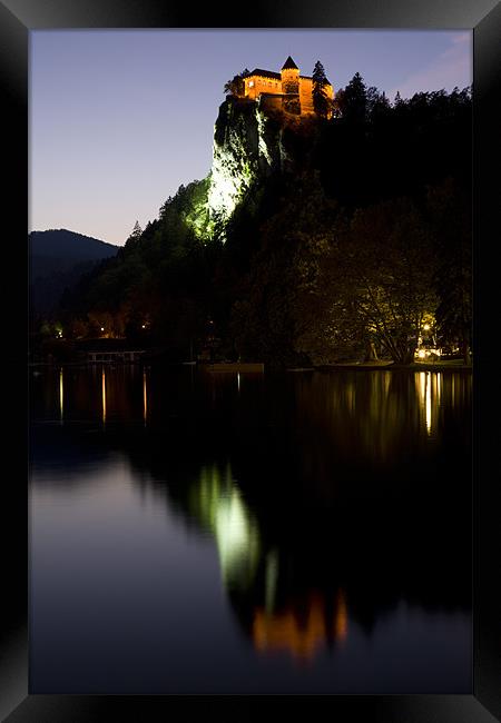 Lake Bled castle reflected at dusk Framed Print by Ian Middleton