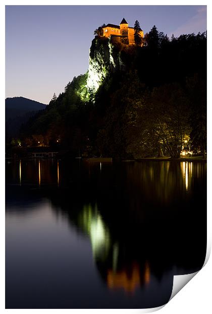 Lake Bled castle reflected at dusk Print by Ian Middleton