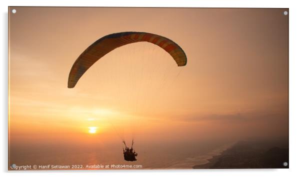 Tandem paragliding over sea and beach while golden Acrylic by Hanif Setiawan