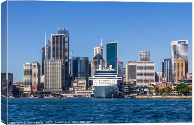Cruise ship moored in Sydney Harbour with the Central Business D Canvas Print by Kevin Hellon