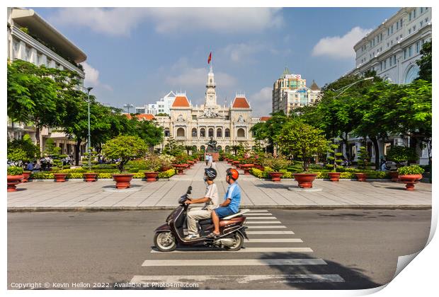 A motorcyclist rides along the road.past a statue of Ho Chi Minh Print by Kevin Hellon