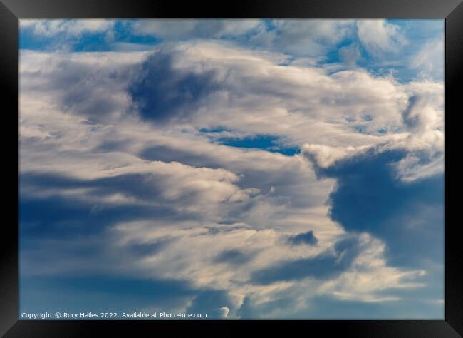 Clouds against a blue sky Framed Print by Rory Hailes