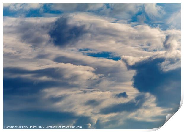 Clouds against a blue sky Print by Rory Hailes