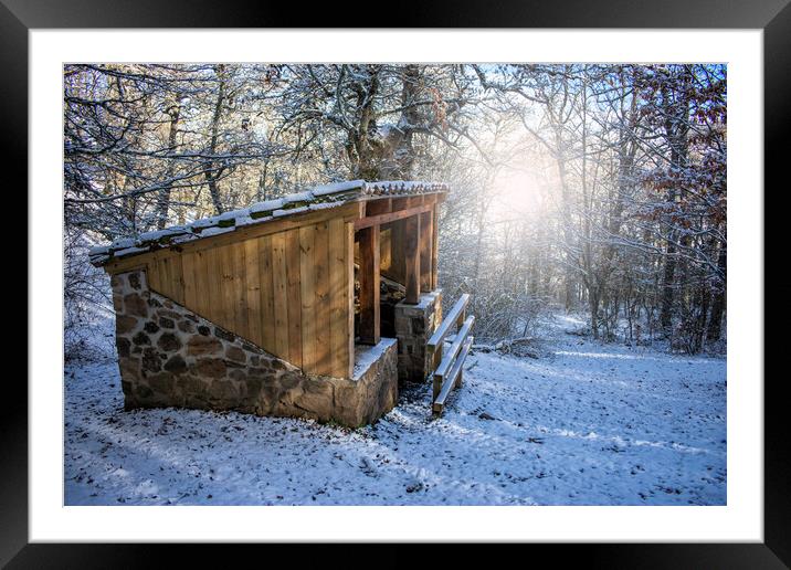 wood and stone cabin in the snowy forest at sunrise at sunrise Framed Mounted Print by David Galindo