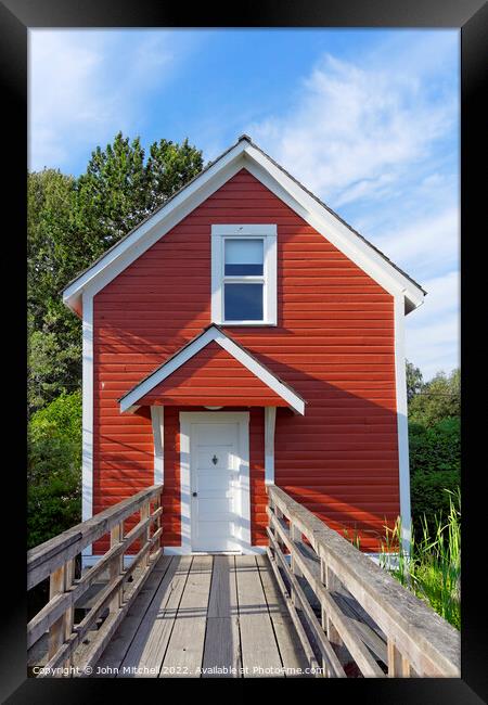 Red Wooden Stilt House Framed Print by John Mitchell
