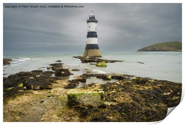 Penmon lighthouse sits at the start of the Menai Strait across f Print by Peter Stuart