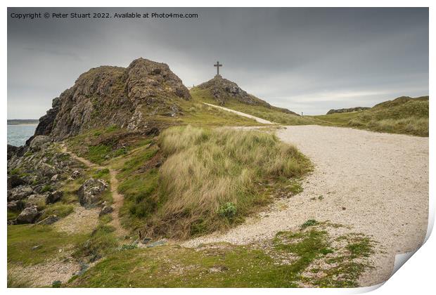 The stone cross overlooks the Llanddwyn beaches and lighthouses  Print by Peter Stuart