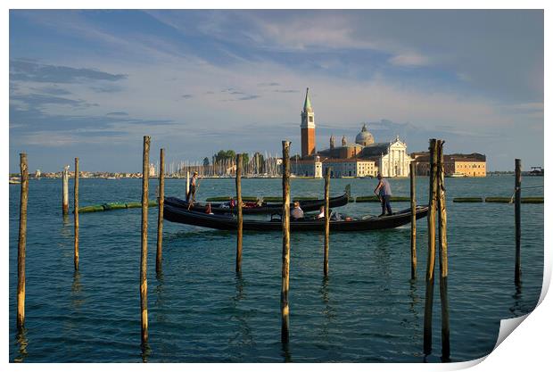 Venice, Italy  Wide angle shot gondolas floating in the canal against View of Bell Tower of St Mark Basilica in Venezia city and dramatic blue sky Print by Arpan Bhatia