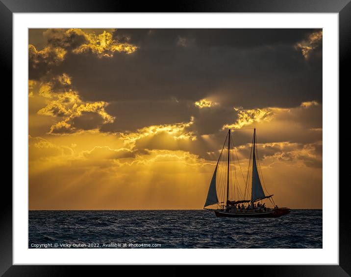 A boat in a large body of water at Sunset  Framed Mounted Print by Vicky Outen