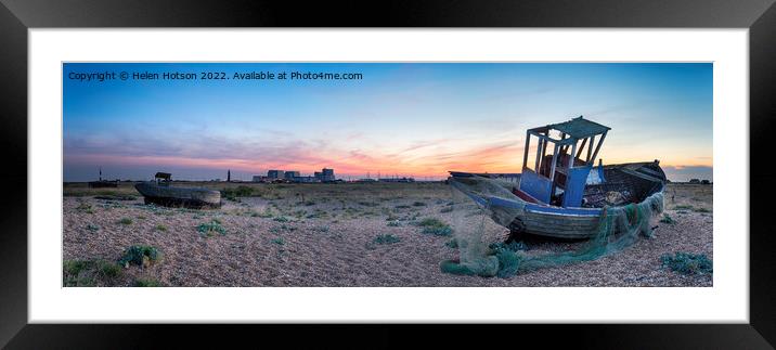 An old wrecked fishing boats at Dungeness in Kent with the two lighthouses and Dungeness B nuclear power station in the background Framed Mounted Print by Helen Hotson