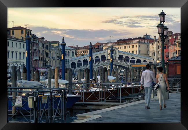 Venice, Italy A couple walking holding hands against rialto bridge, a famous place known as one of the romantic destination Framed Print by Arpan Bhatia