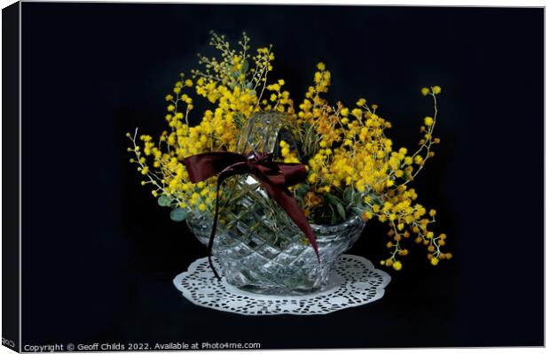 Wattle blossoms in a crystal glass basket vase on black. Wattle  Canvas Print by Geoff Childs
