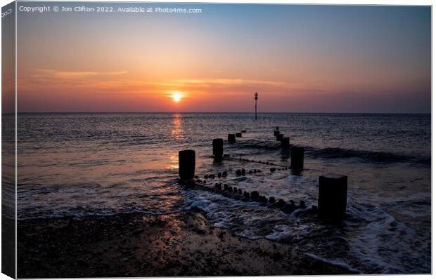 A sunset over a body of water Canvas Print by Jon Clifton