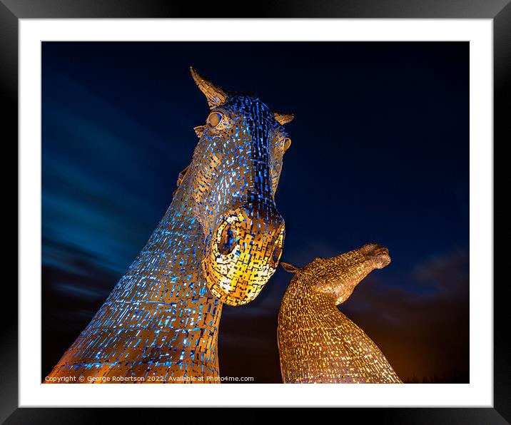 The Kelpies light up in Blue and Yellow colours in support of Uk Framed Mounted Print by George Robertson