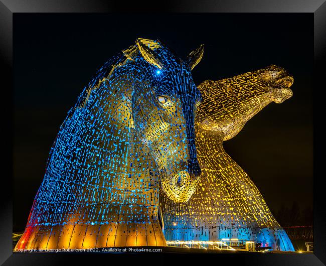 The Kelpies in support of Ukraine are light up in blue and yello Framed Print by George Robertson