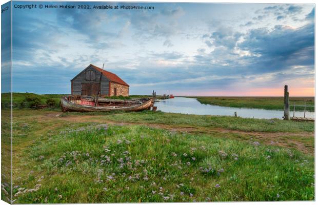 Dramatic sunrise sky over the old coal barn at Thornham Canvas Print by Helen Hotson