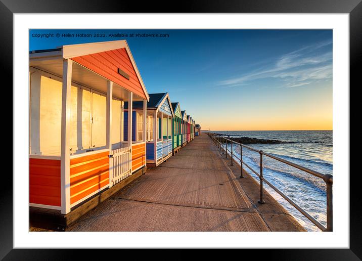 A row of pretty beach huts at Southwold  Framed Mounted Print by Helen Hotson