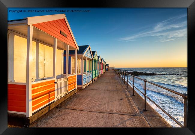 A row of pretty beach huts at Southwold  Framed Print by Helen Hotson