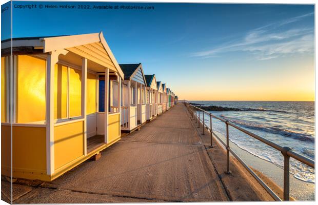 Colorful beach huts on the prom at Southwold Canvas Print by Helen Hotson