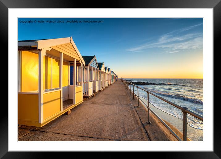 Colorful beach huts on the prom at Southwold Framed Mounted Print by Helen Hotson